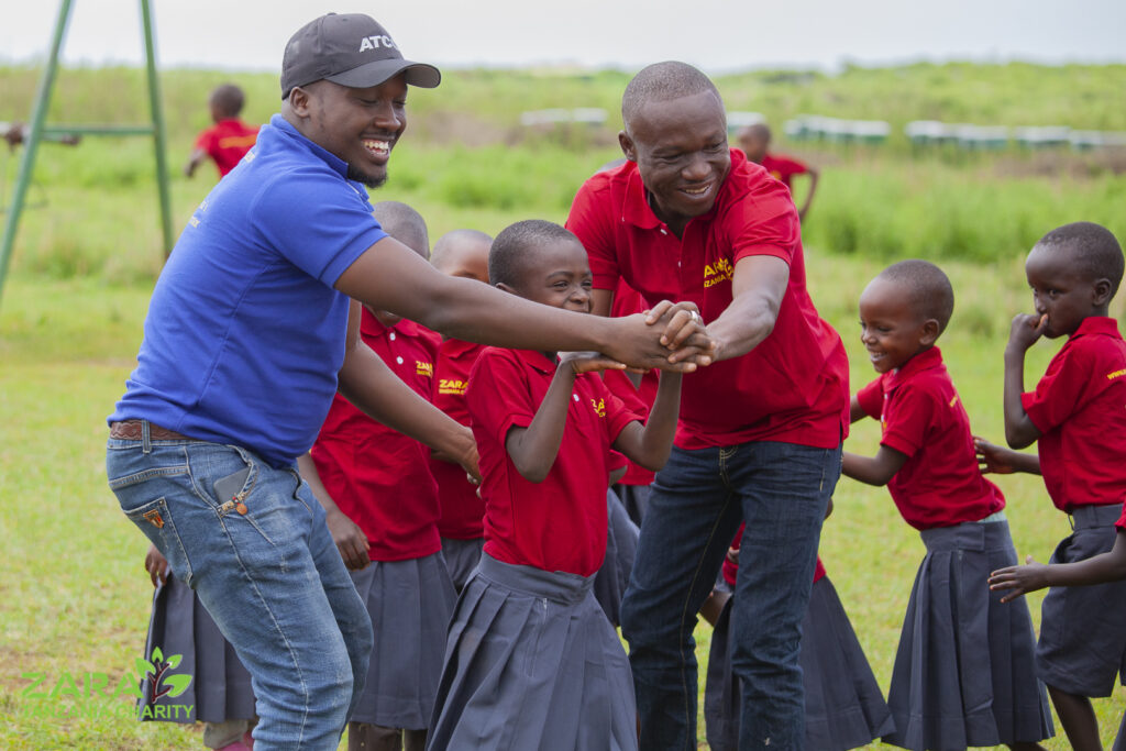 Community members volunteering at education charity in Tanzania