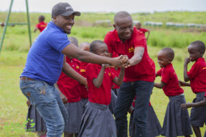 Community members volunteering at education charity in Tanzania